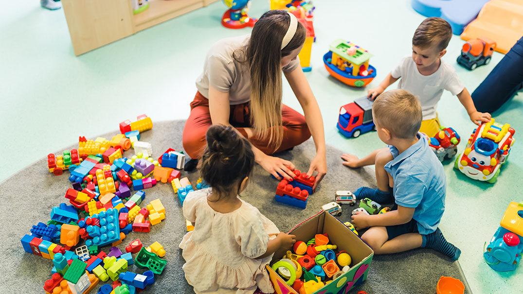 Teacher Supervising children during classroom play.