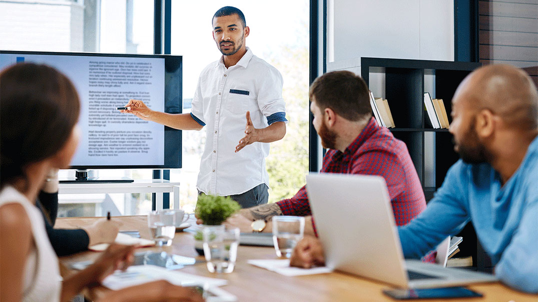 An Educator teaching four other educators from a monitor