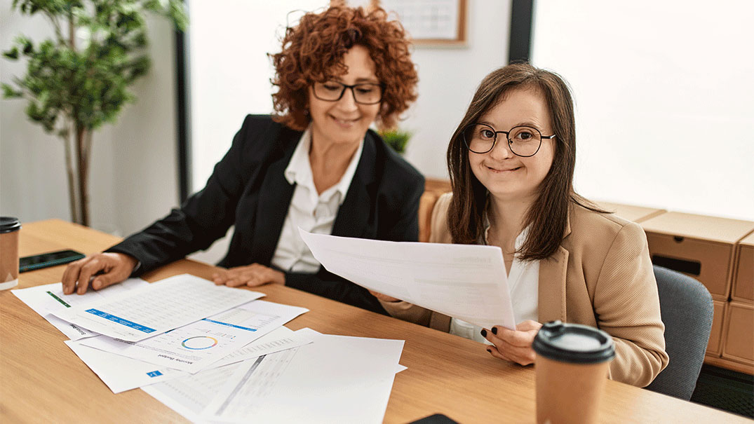 Two women working at the office.