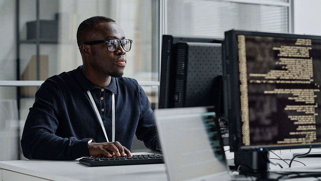 a man sitting at a desk with a computer