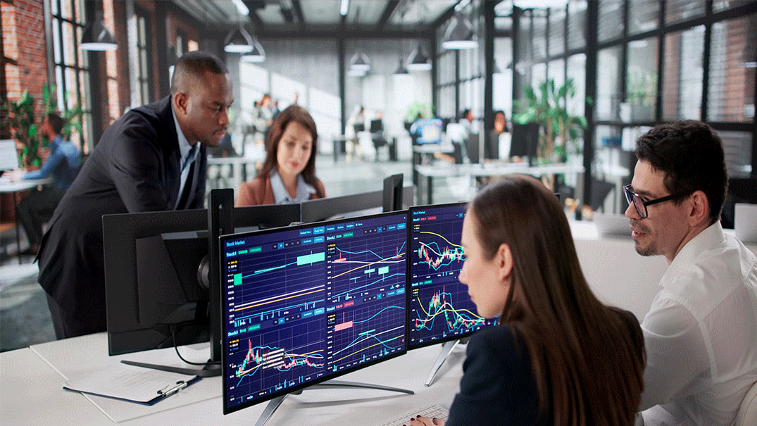 two pairs of people looking at computer screens