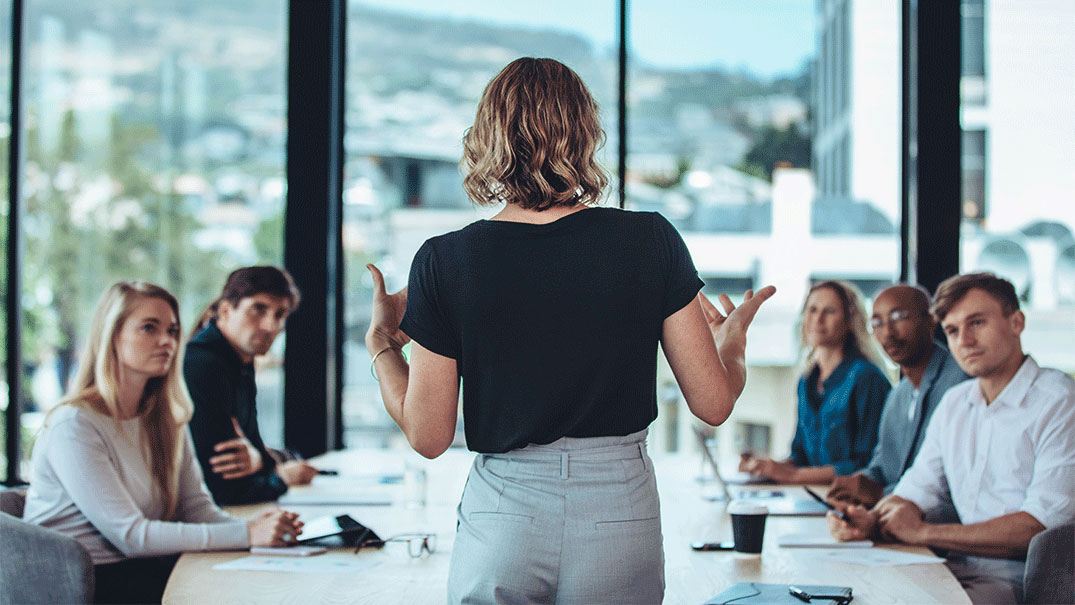 a woman standing in front of a group of people